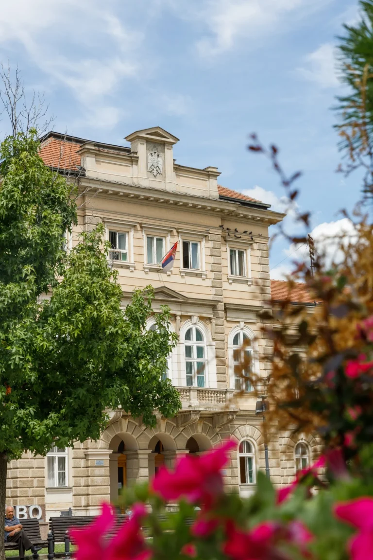 District Court building behind the greenery on the square
